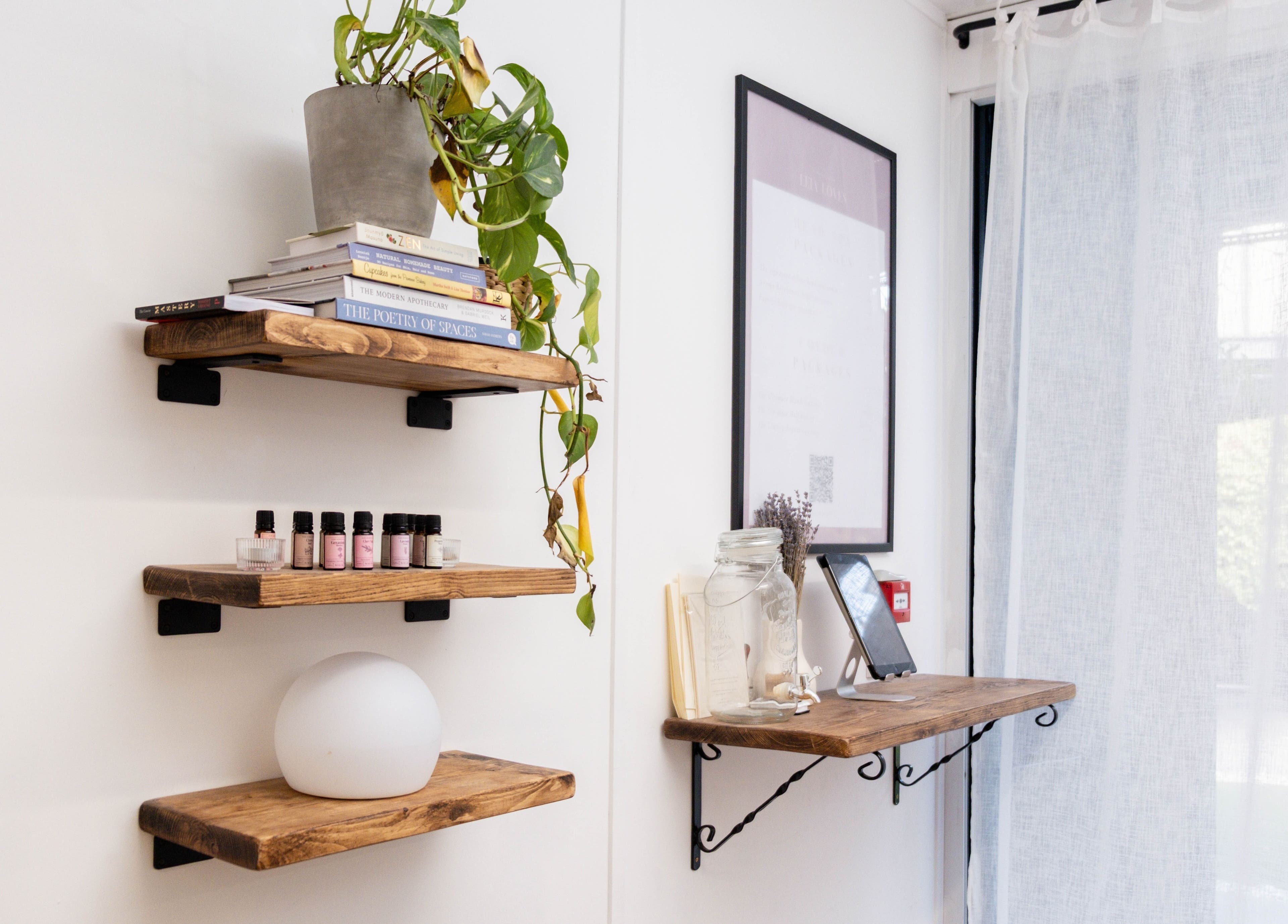 Rustic wooden shelves at Leia Loves, London, England, GB with decor and essential oils.