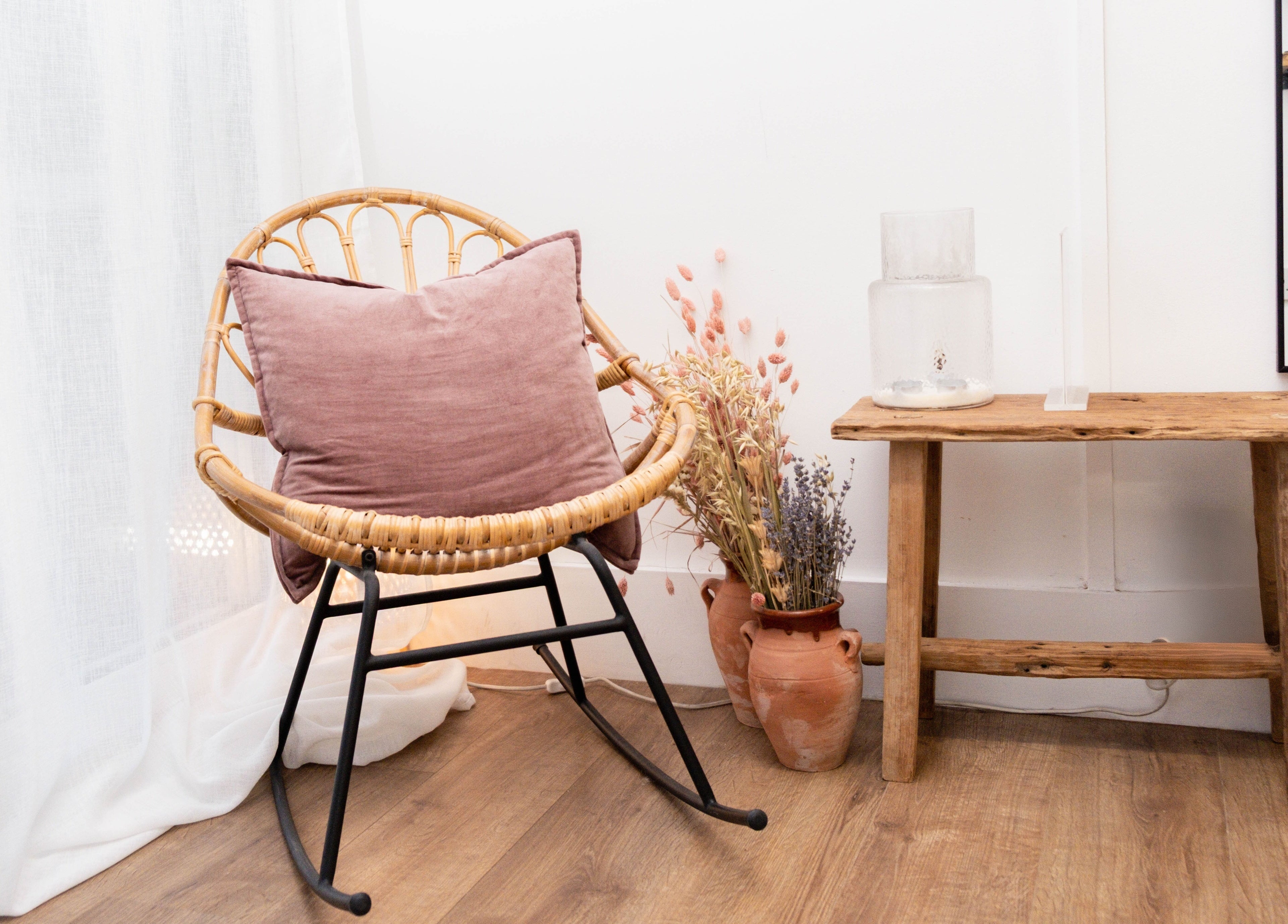 Inviting seating area with wicker chair at Leia Loves, London, England, GB, showcasing rustic decor and natural light.