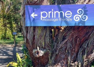 Entrance sign for Prime Massage Therapy (West Auckland) on a tree, located in Auckland, Auckland, NZ.