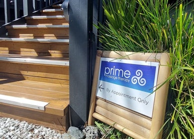 Entrance to Prime Massage Therapy (West Auckland) in Auckland, NZ with a welcoming sign by lush greenery.
