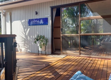 Bright outdoor deck at Prime Massage Therapy (West Auckland), Auckland, NZ with lush greenery view.