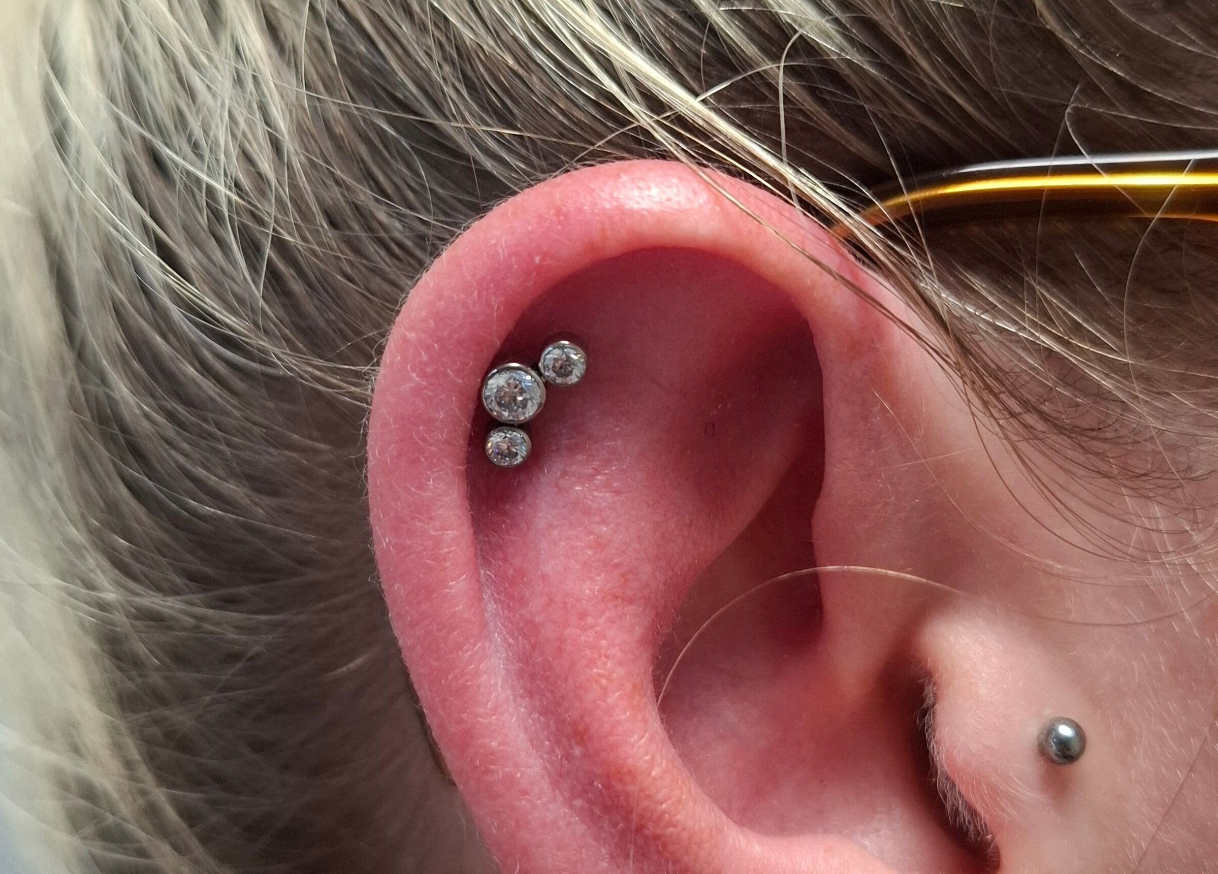 Stylish ear piercings with gemstones at Starry Moon Beauty Swords, Swords, County Dublin, IE.