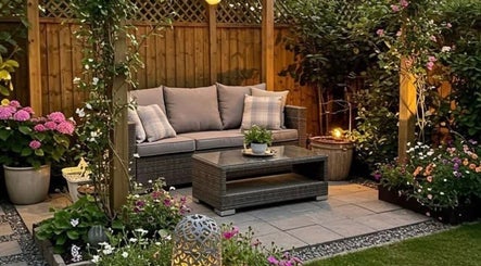 Relaxing garden seating at Beauty by Pippa, Burton upon Trent, England, GB, surrounded by lush flowers.