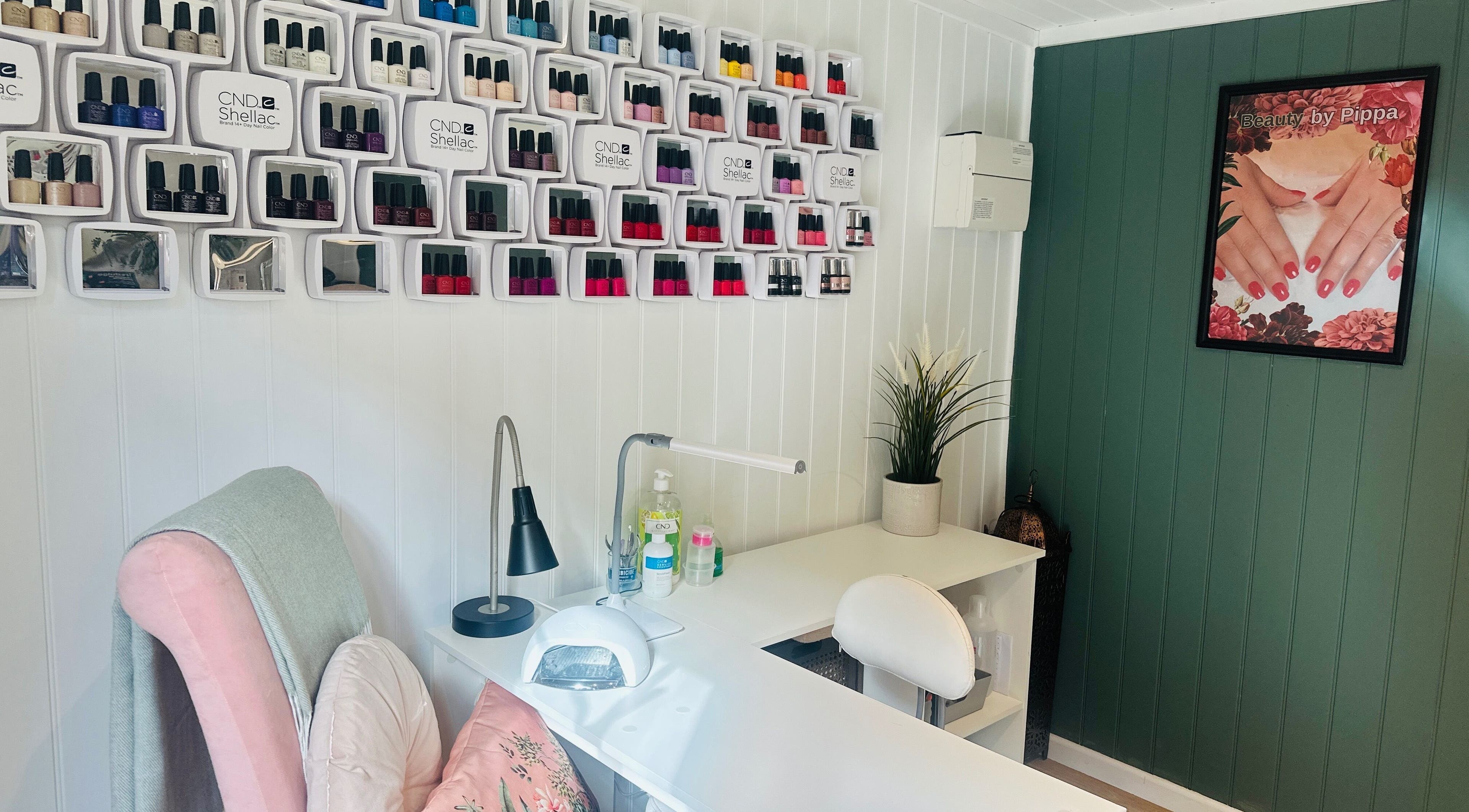 Nail salon interior at Pippa Hutchison Beauty, Burton upon Trent, England, GB, featuring nail polish wall display.