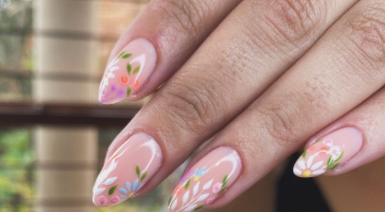Elegant floral nail art at Mari-cles in Pretoria, Gauteng, ZA, showcasing intricate detail and vibrant colors.