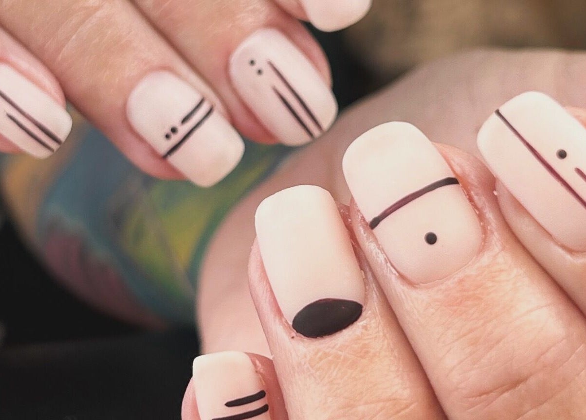 Chic geometric nail art at Mari-cles, Pretoria, Gauteng, ZA, showcasing minimalist black lines on nude polish.