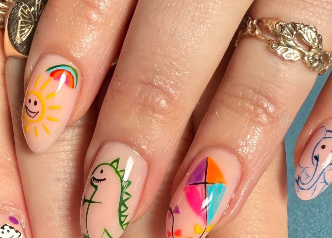 Colorful whimsical nail art at Mari-cles, Pretoria, Gauteng, ZA shows playful sun, dinosaur, and elephant designs.