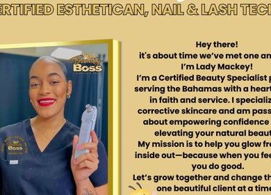 Certified esthetician at The Beauty Boss Bureau in Nassau, New Providence, BS, smiling with a skincare device.