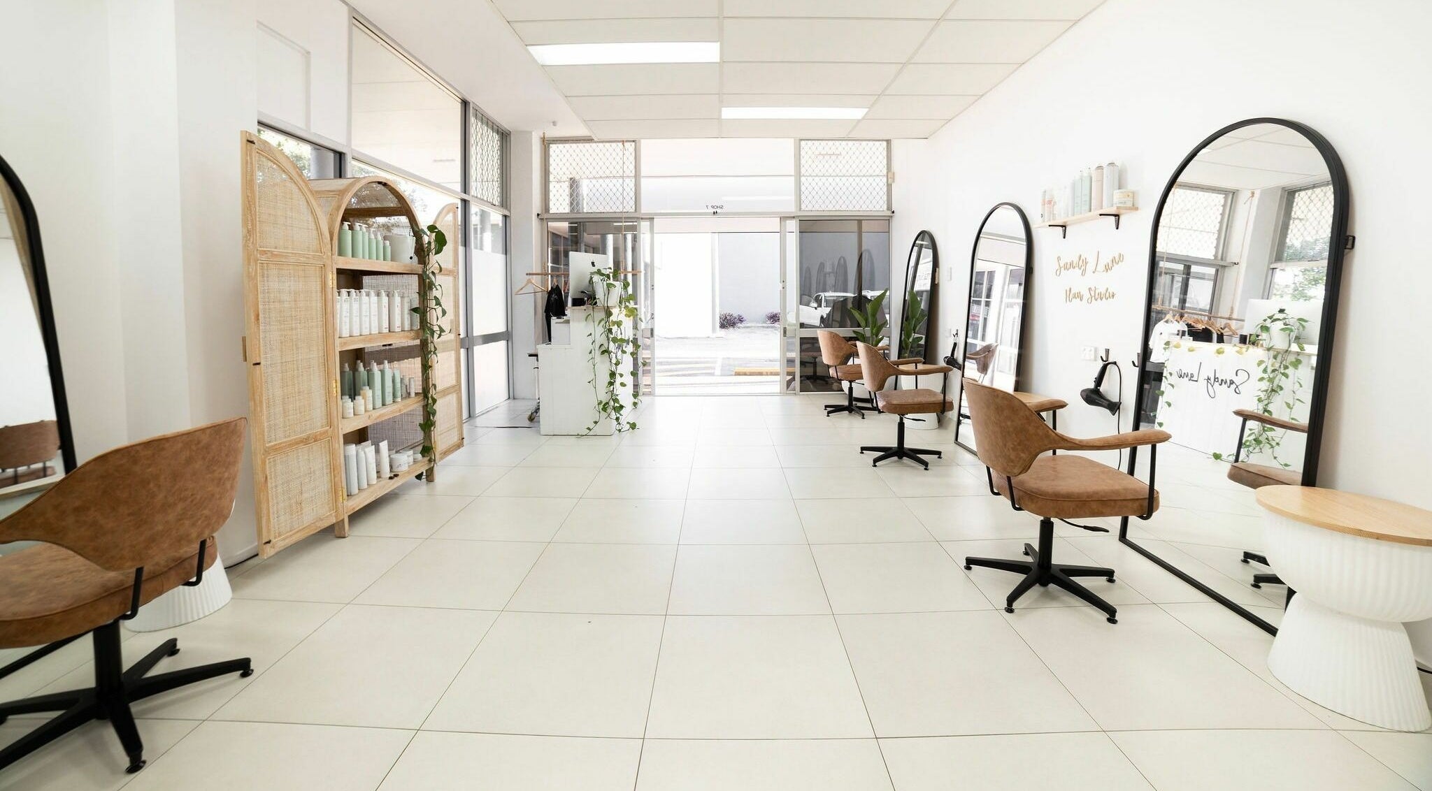 Modern interior of Sandy Lane Hair Studio - Manly, featuring stylish chairs and mirrors in Manly, Queensland, AU.