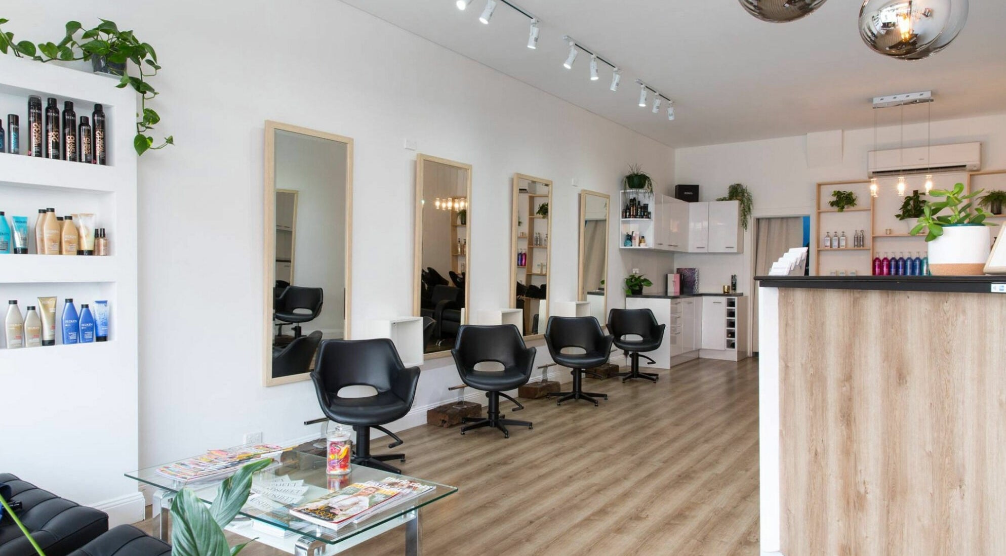 Modern interior of Bondi Colour salon in Bondi, New South Wales, AU featuring sleek chairs and stylish decor.