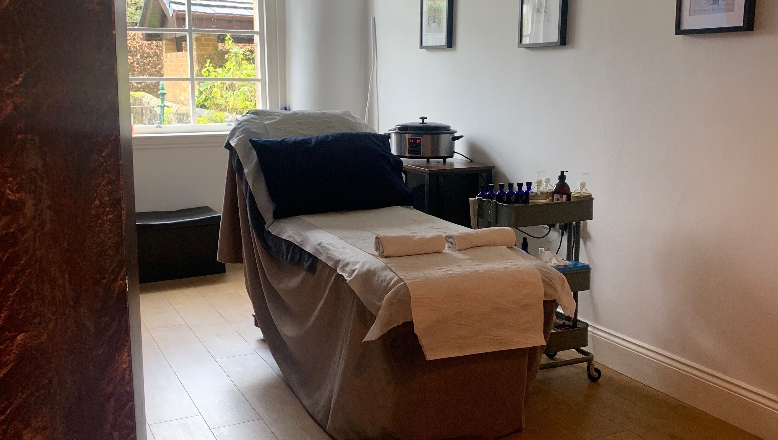 Cozy therapy room at Sans Peur Therapies, Lenzie, Scotland, GB, with massage table and soothing decor.