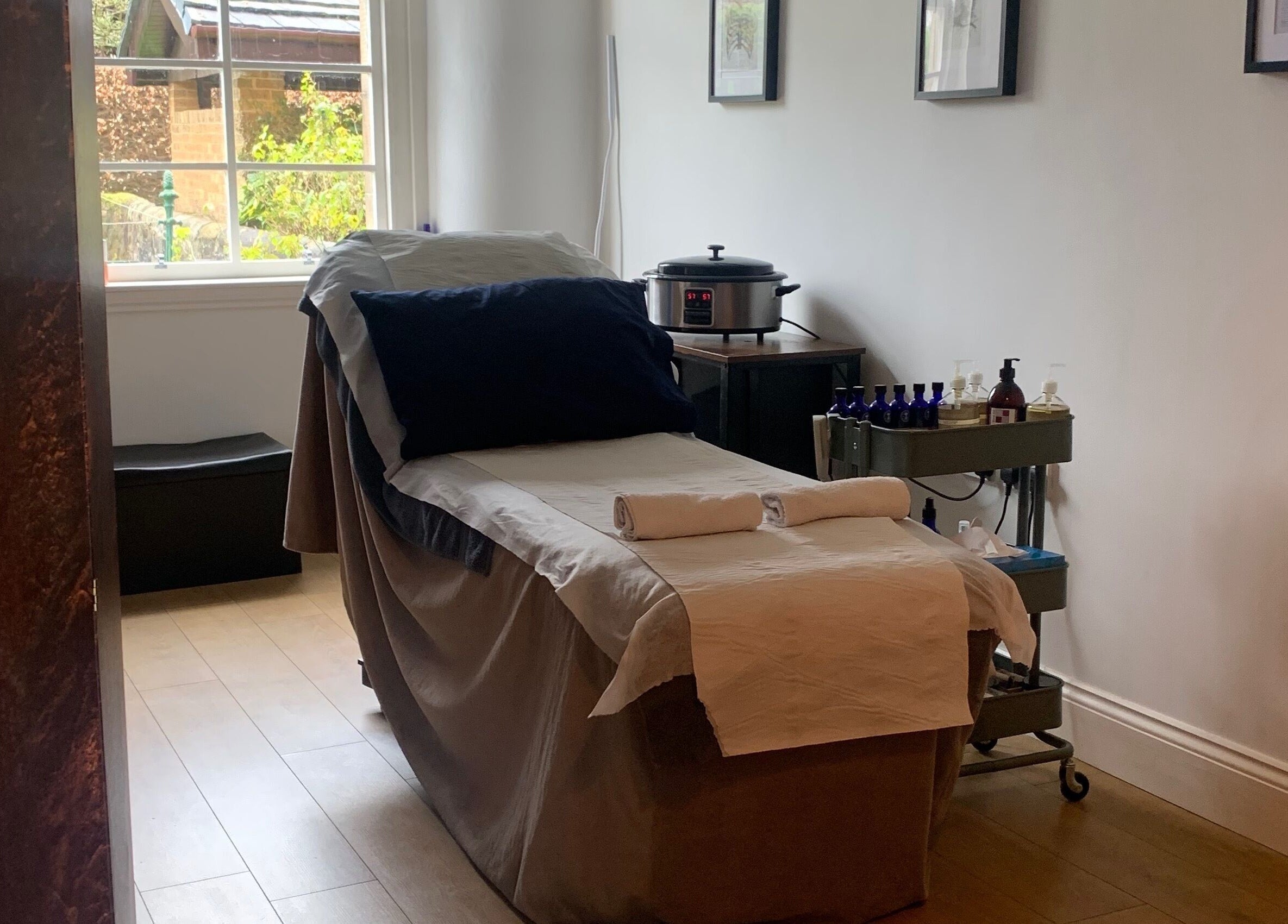 Cozy therapy room at Sans Peur Therapies, Lenzie, Scotland, GB, with massage table and soothing decor.
