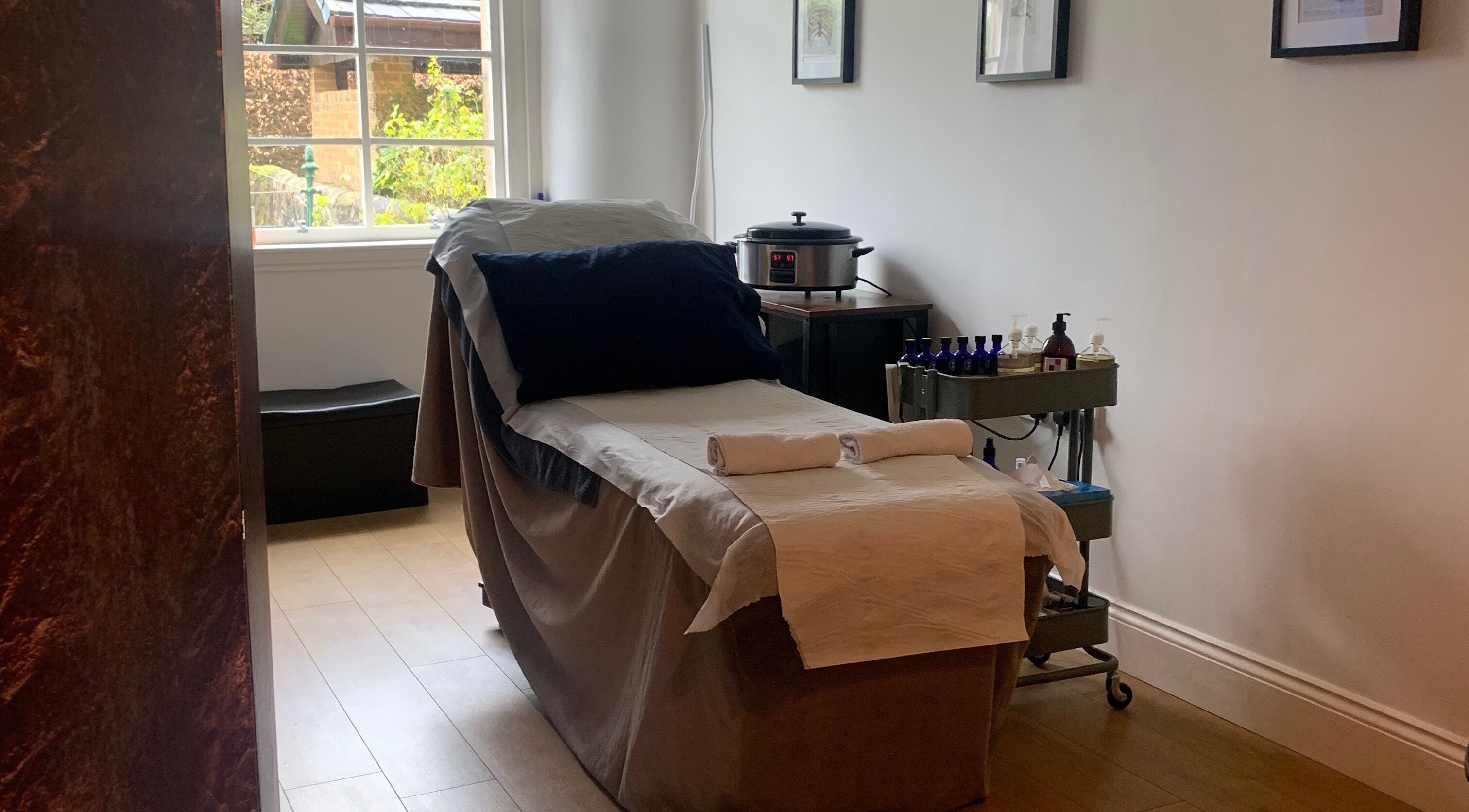 Cozy therapy room at Sans Peur Therapies, Lenzie, Scotland, GB, with massage table and soothing decor.