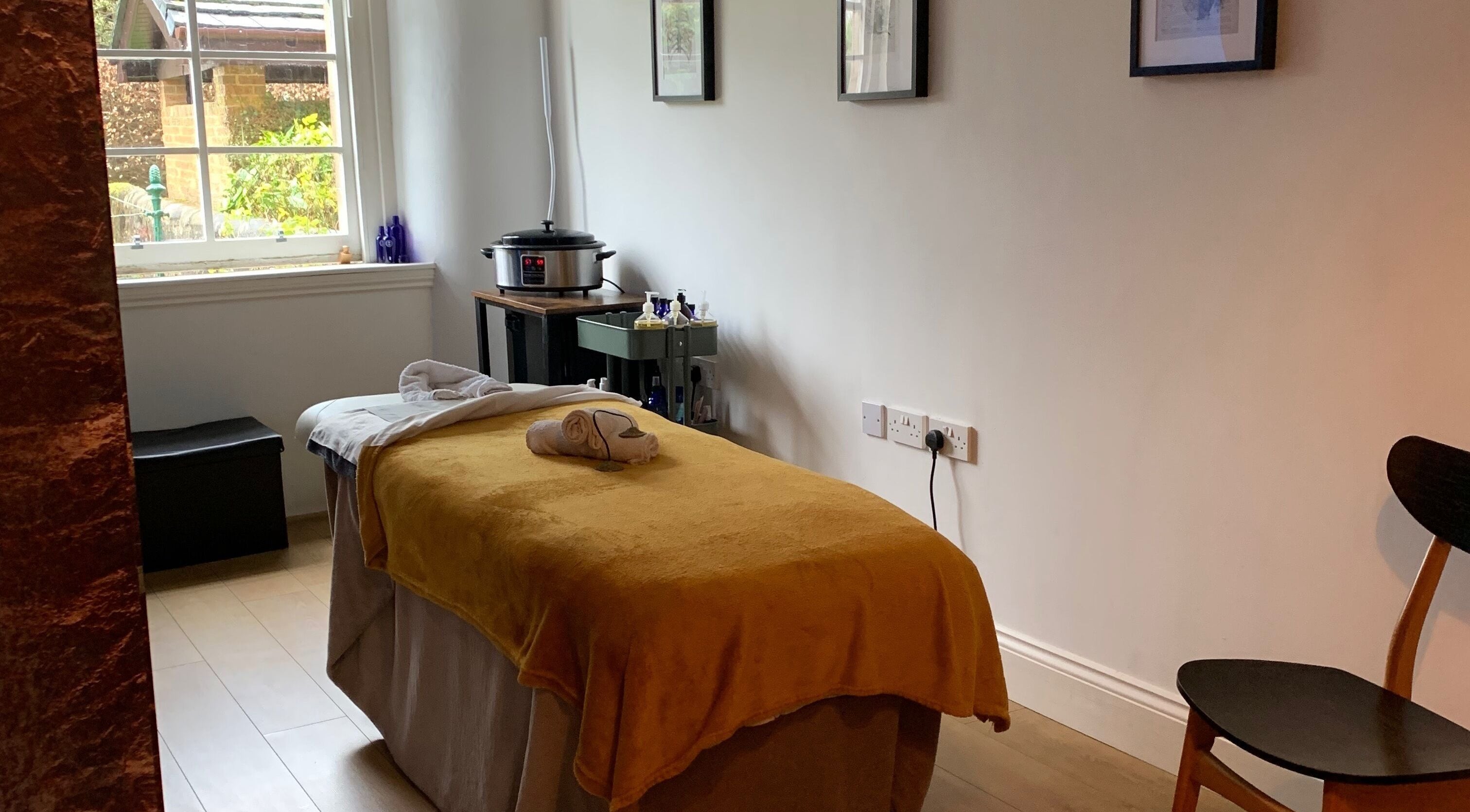 Peaceful therapy room at Sans Peur Therapies in Lenzie, Scotland, GB with massage table and natural light.