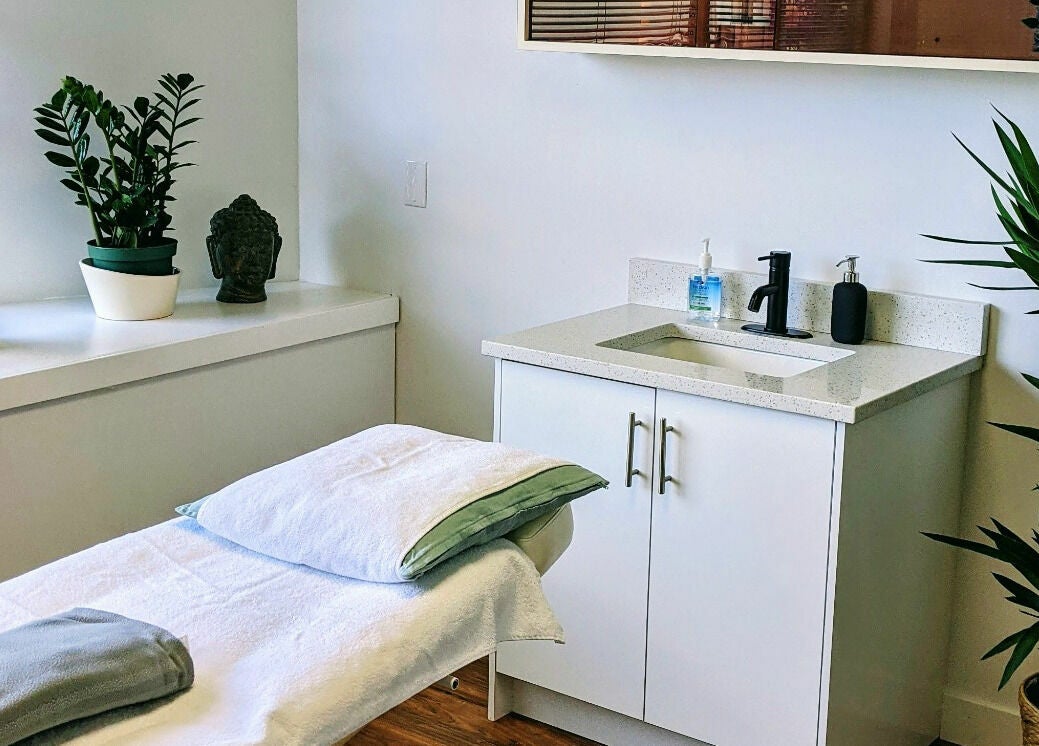 Relaxing spa room at Clarico Electrolysis + Advanced Aesthetics, Vancouver, BC, CA with a cozy treatment bed.