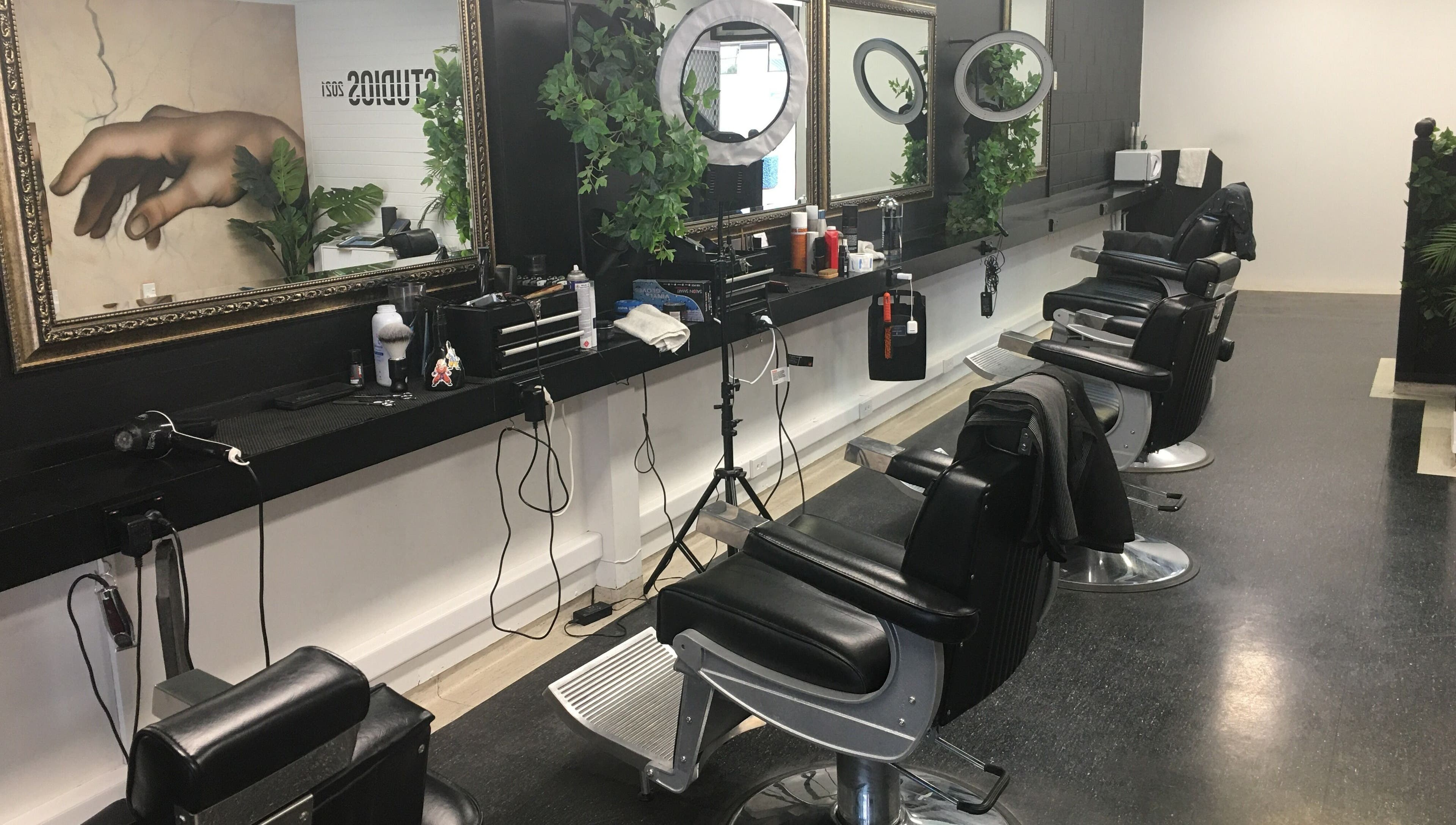 Chic barber chairs and mirrors at Ice Studios, Palmerston North, Manawatu-Wanganui, NZ with elegant decor.