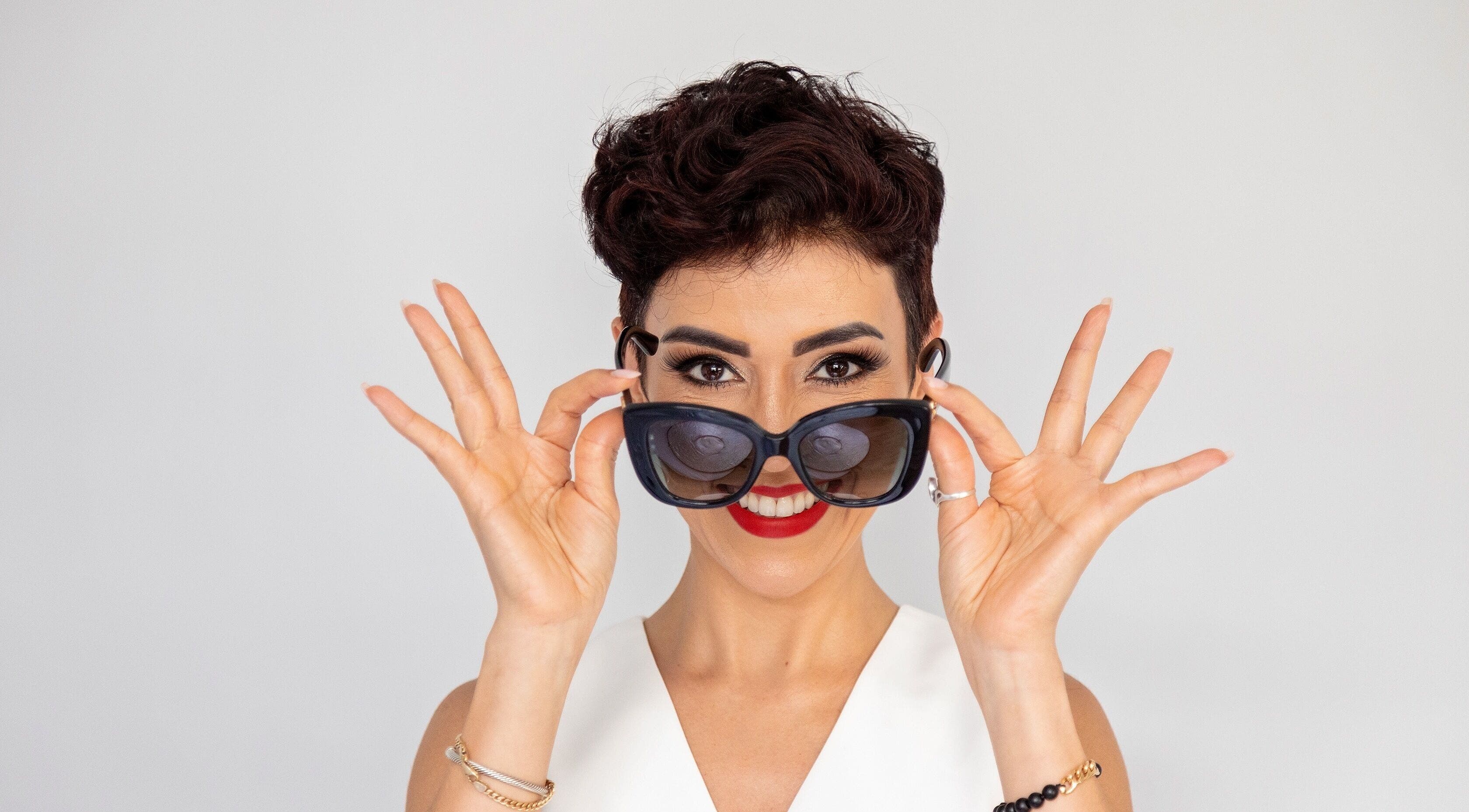 Smiling woman with sunglasses at Privé Faces, Ashburn, Virginia, US.