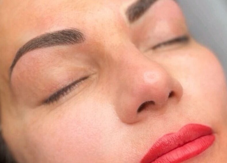Close-up of a woman with flawless skin and red lips at Privé Faces, Ashburn, Virginia, US.