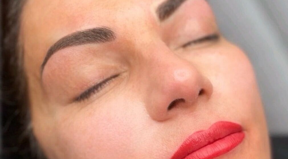 Close-up of a woman with flawless skin and red lips at Privé Faces, Ashburn, Virginia, US.