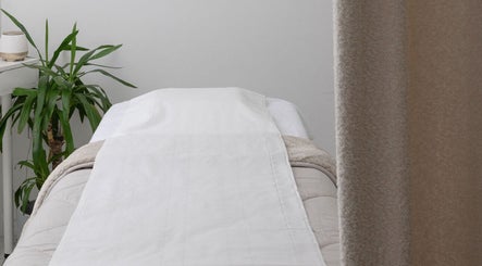 Relaxing treatment room at The Beauty Shack, Failand, England, GB with cozy decor and leafy plant.