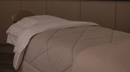 Comfortable treatment bed at The Beauty Shack in Failand, England, GB, ready for a relaxing session.