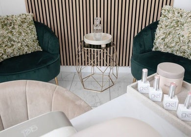 Elegant seating nook at The Beauty Shack in Failand, England, GB with plush chairs and nail products.