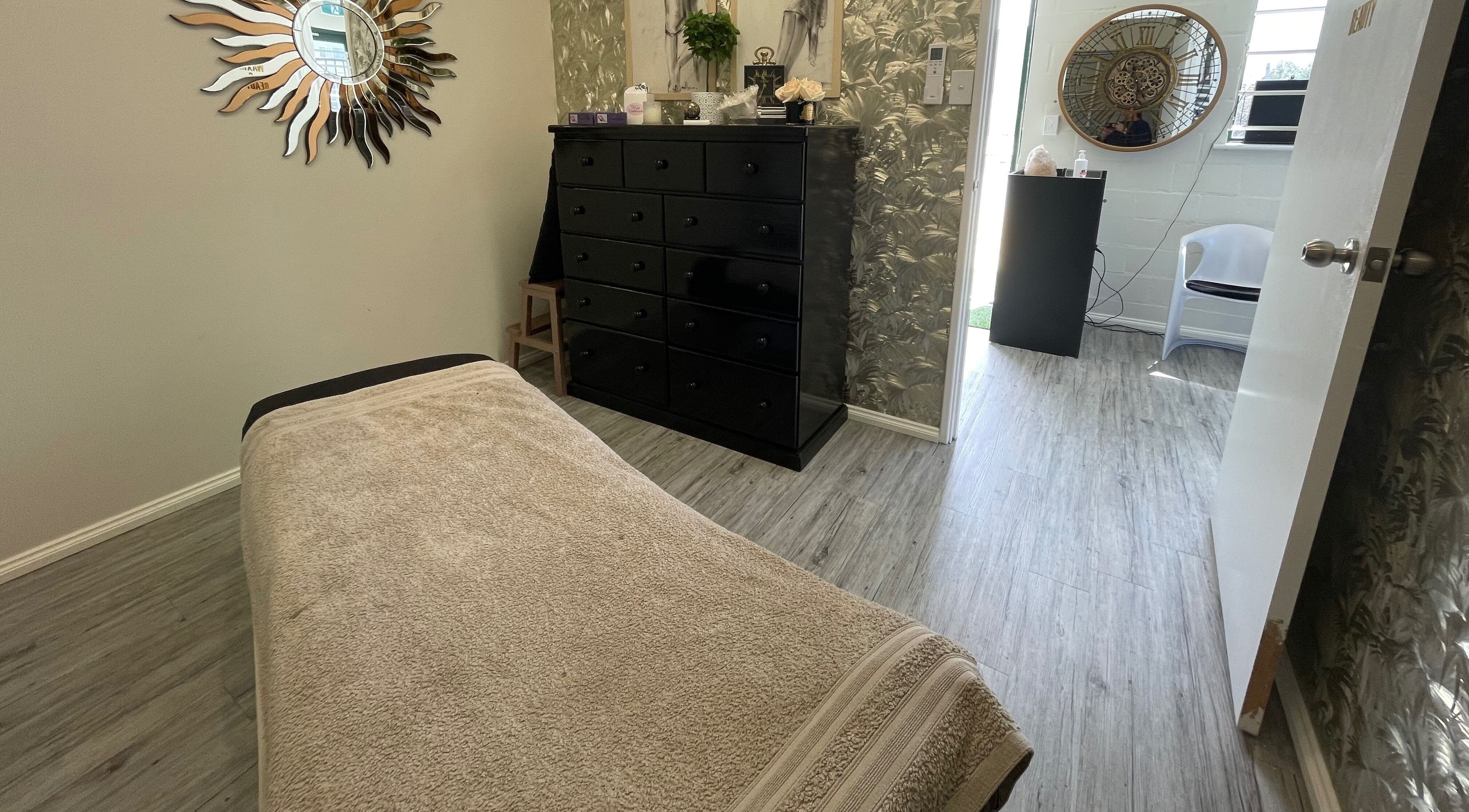 Tranquil spa room at Body N Beauty Wellness Malaga, Western Australia, featuring elegant decor and massage table.