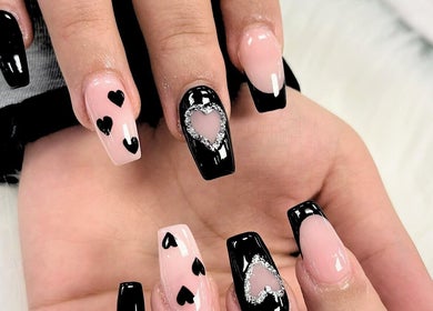 Stylish heart nail art at Royal Nails & Beauty Kelston in Auckland, NZ, showcasing black tips with heart designs.