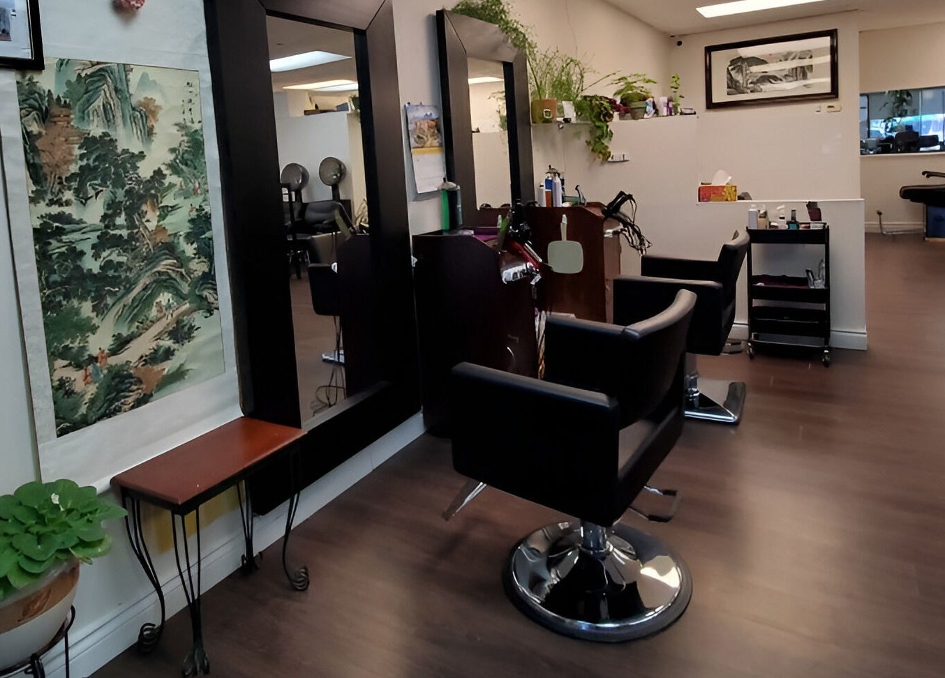 Chic interior of Purple Jade Hair Design in Calgary, Alberta, CA, featuring stylish chairs and lush plants.