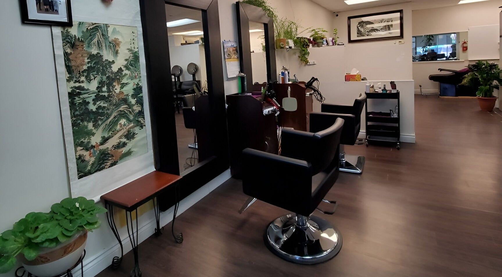 Chic interior of Purple Jade Hair Design in Calgary, Alberta, CA, featuring stylish chairs and lush plants.
