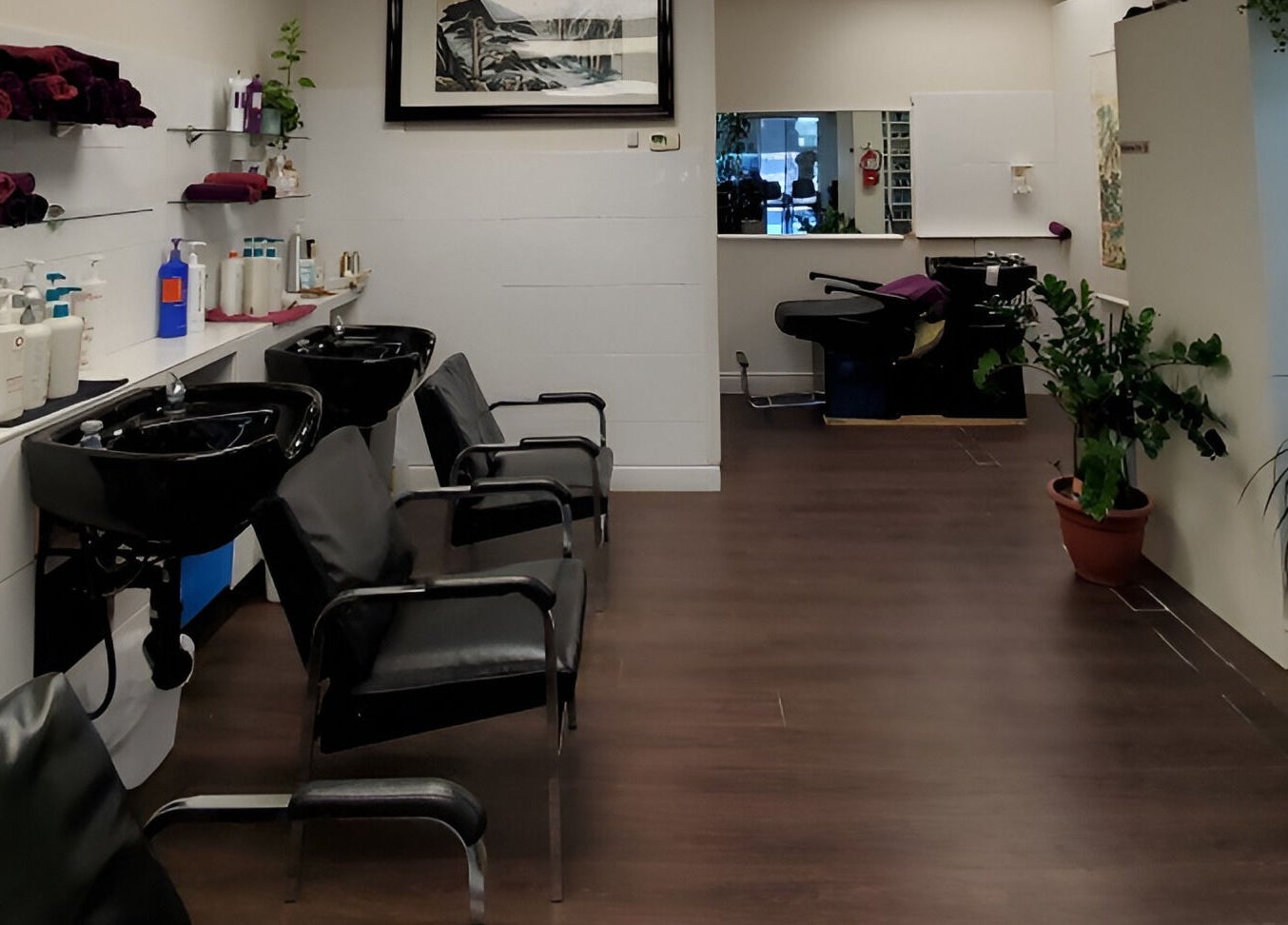 Interior of Purple Jade Hair Design, a sleek salon in Calgary, Alberta, CA with black chairs and modern decor.