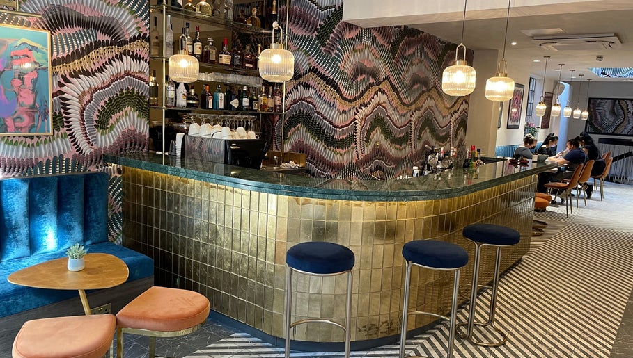 Stylish bar with vibrant decor at Iris Avenue, London, England, GB offering a chic wellness experience.