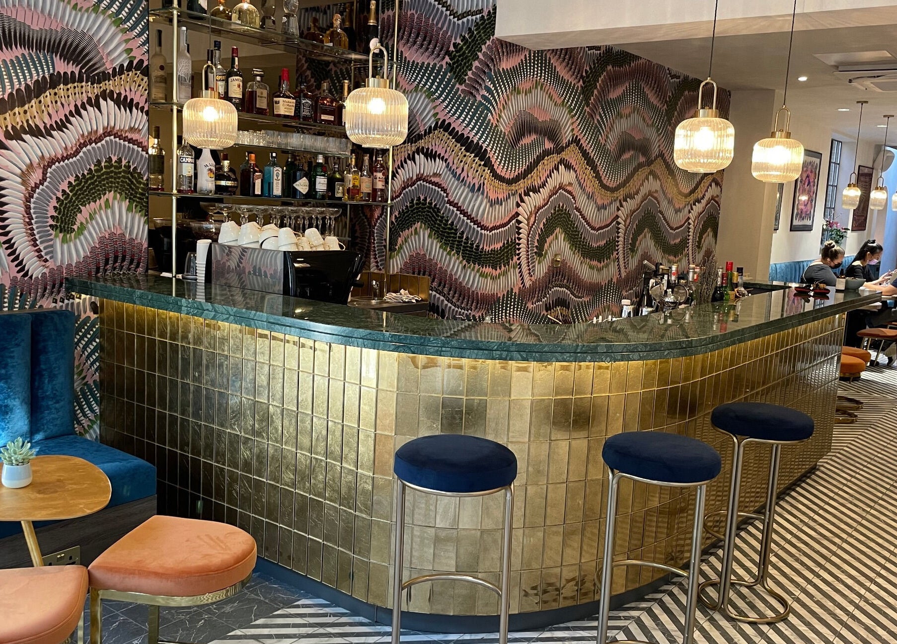 Stylish bar with vibrant decor at Iris Avenue, London, England, GB offering a chic wellness experience.