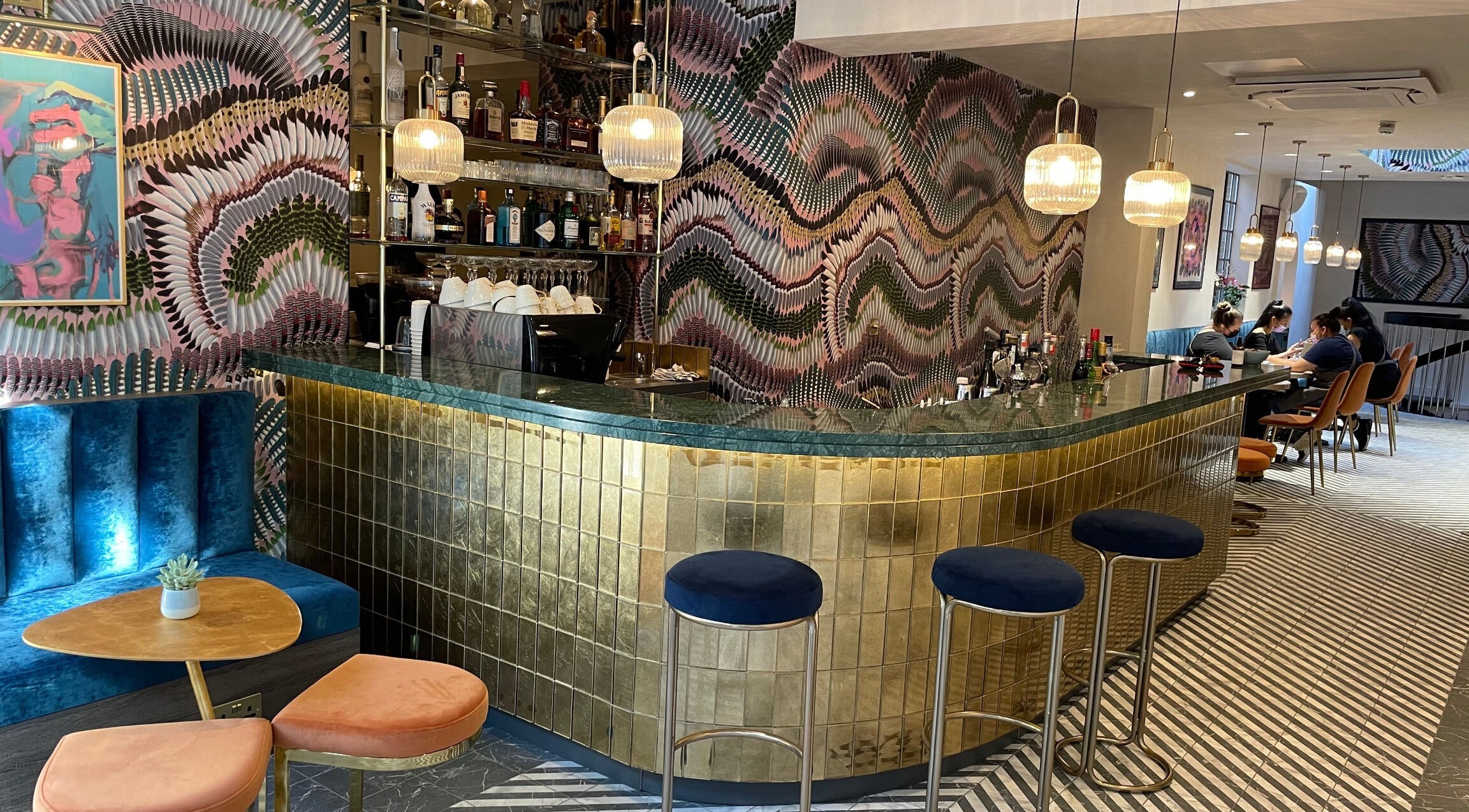 Stylish bar with vibrant decor at Iris Avenue, London, England, GB offering a chic wellness experience.