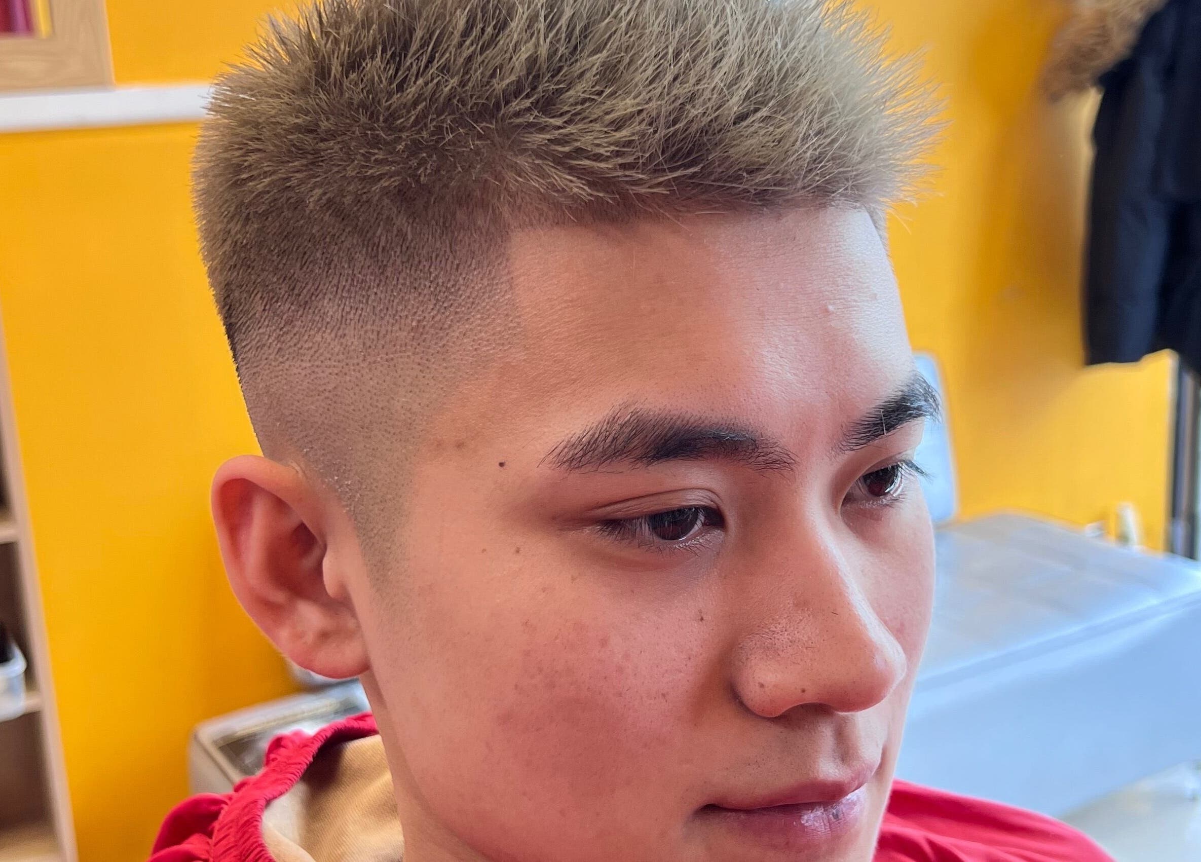 Close-up of a fresh fade haircut at Soorya Barbers, Harrow, England, GB in a vibrant, well-lit interior.