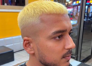 Stylish golden haircut at Soorya Barbers in Harrow, England, GB. Modern barbering techniques showcased.