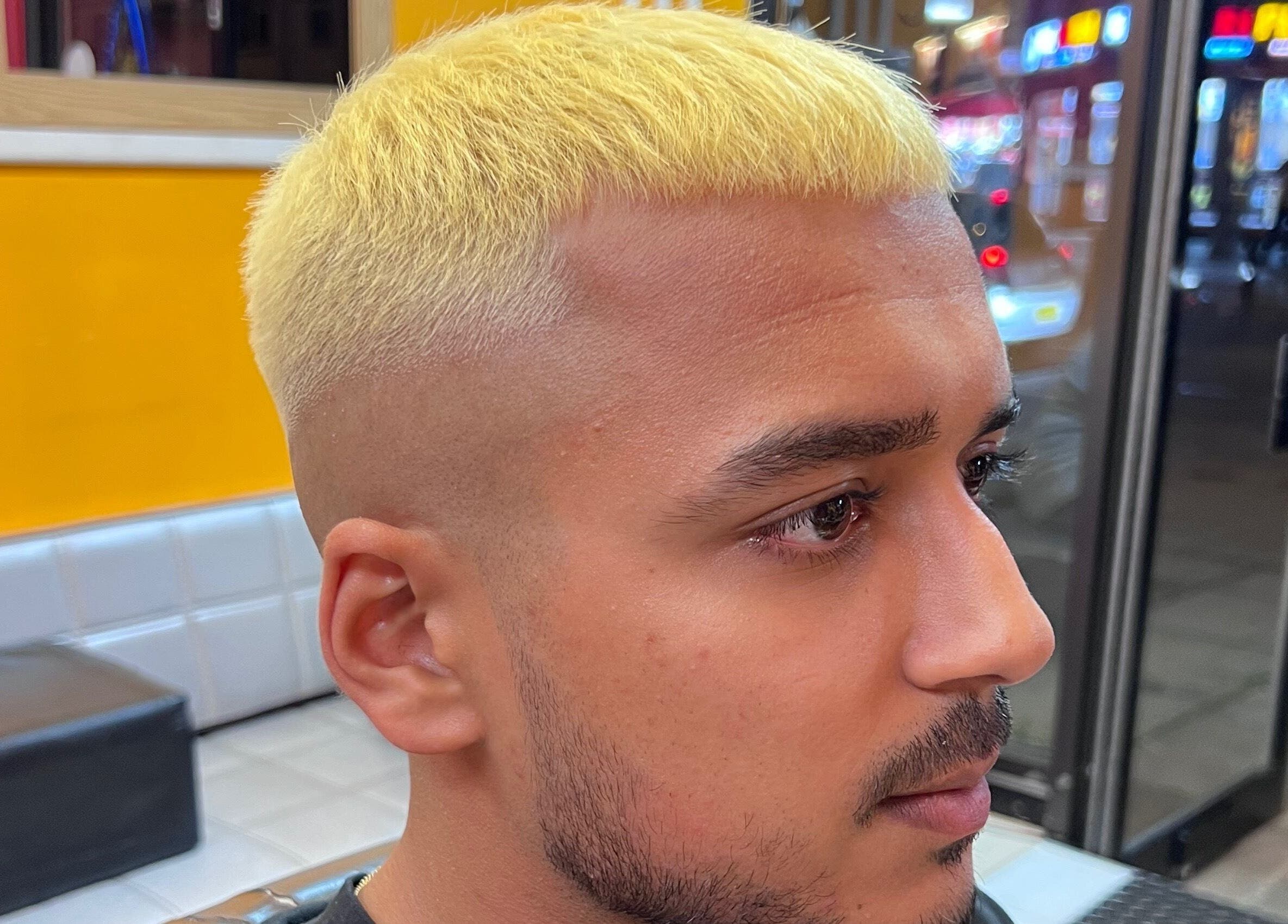 Stylish golden haircut at Soorya Barbers in Harrow, England, GB. Modern barbering techniques showcased.