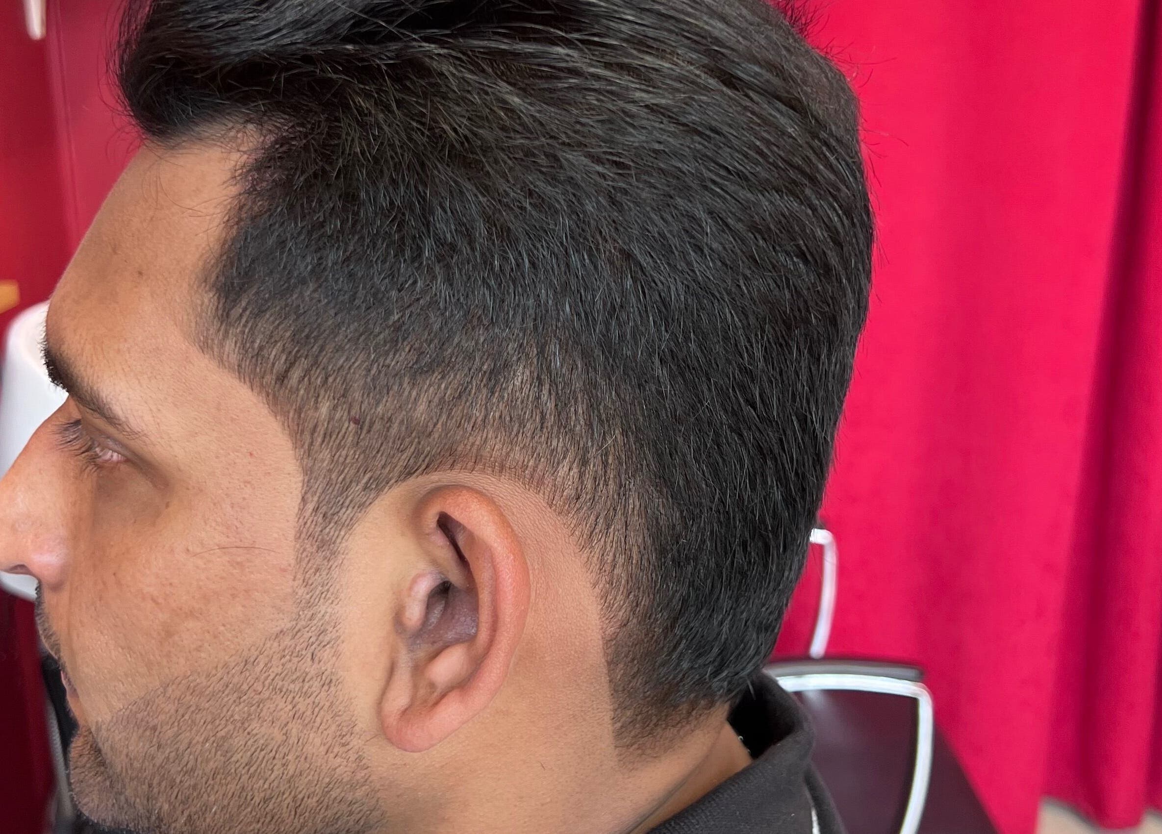Close-up of a fresh haircut at Soorya Barbers in Harrow, England, GB showcasing precise styling.