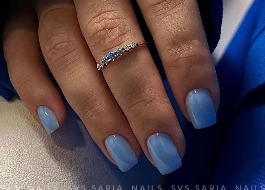 Elegant blue manicure by Saidi Nails in Limassol, Limassol, CY, featuring a delicate silver ring.