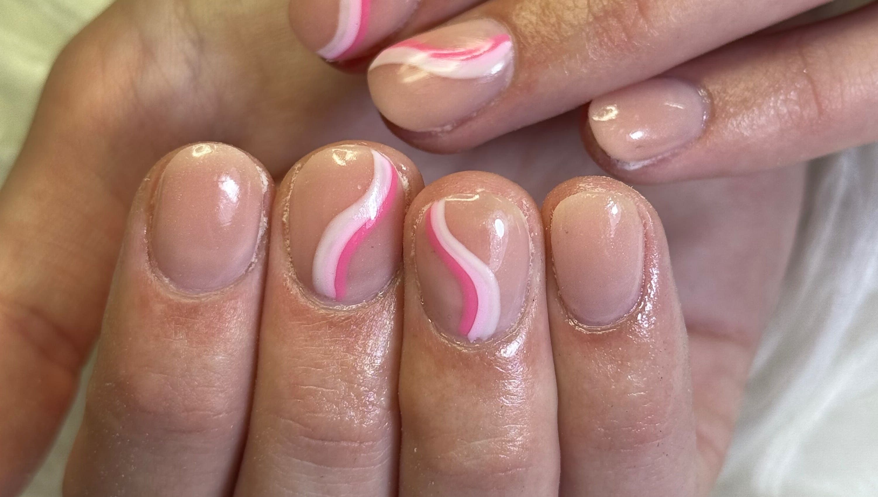 Elegant nail art with pink swirls at Amity Beauty Salon, Potchefstroom, North West, ZA.