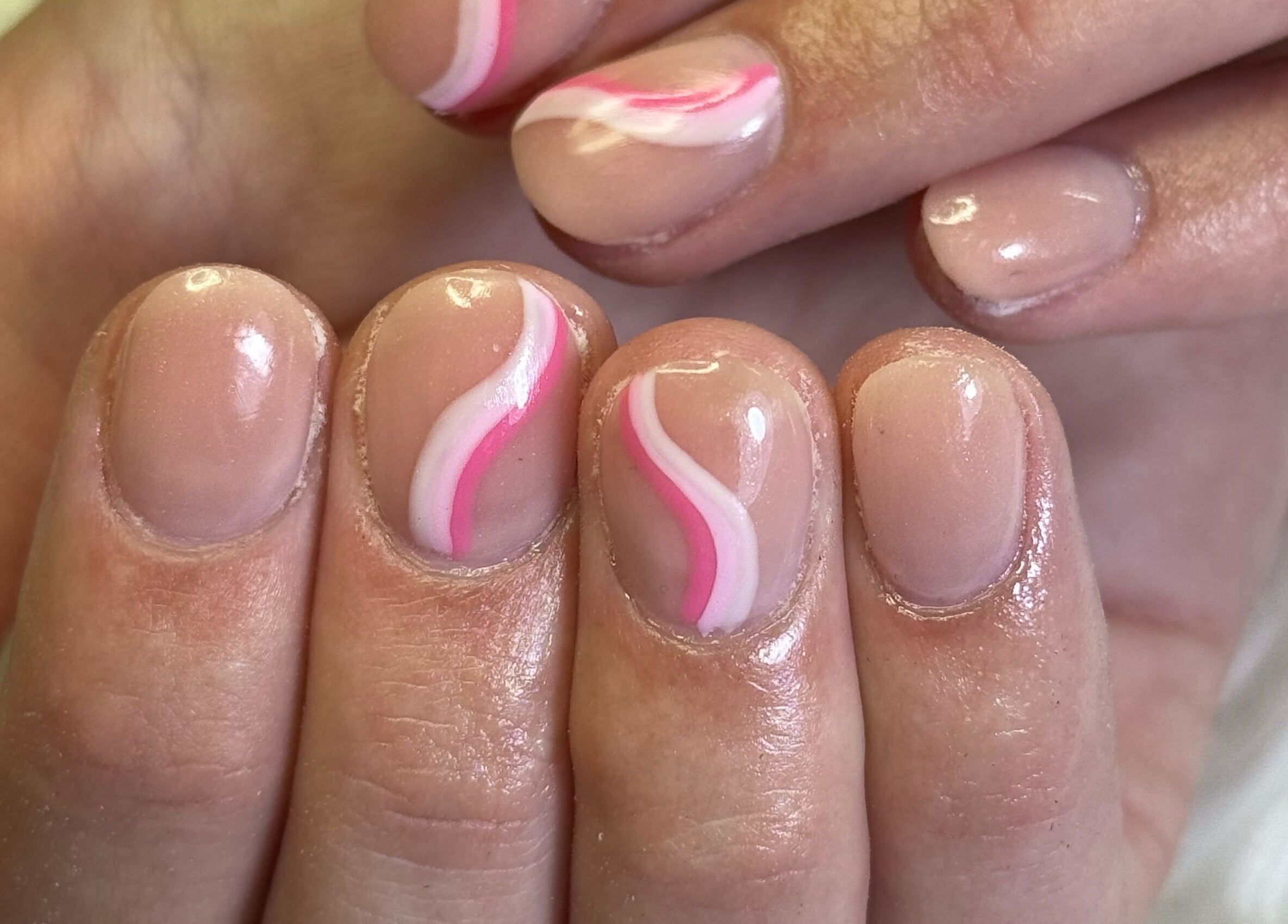 Elegant nail art with pink swirls at Amity Beauty Salon, Potchefstroom, North West, ZA.