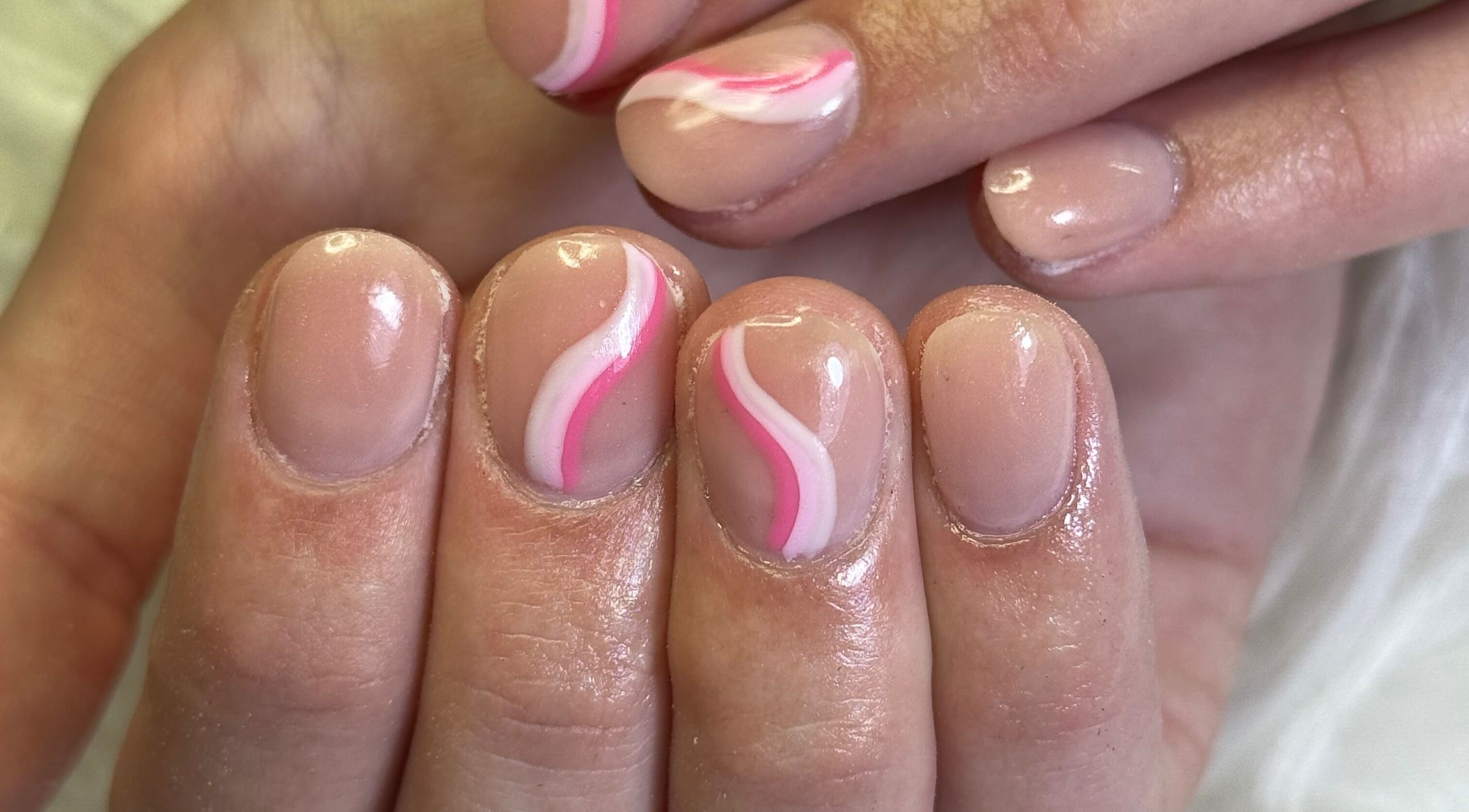 Elegant nail art with pink swirls at Amity Beauty Salon, Potchefstroom, North West, ZA.