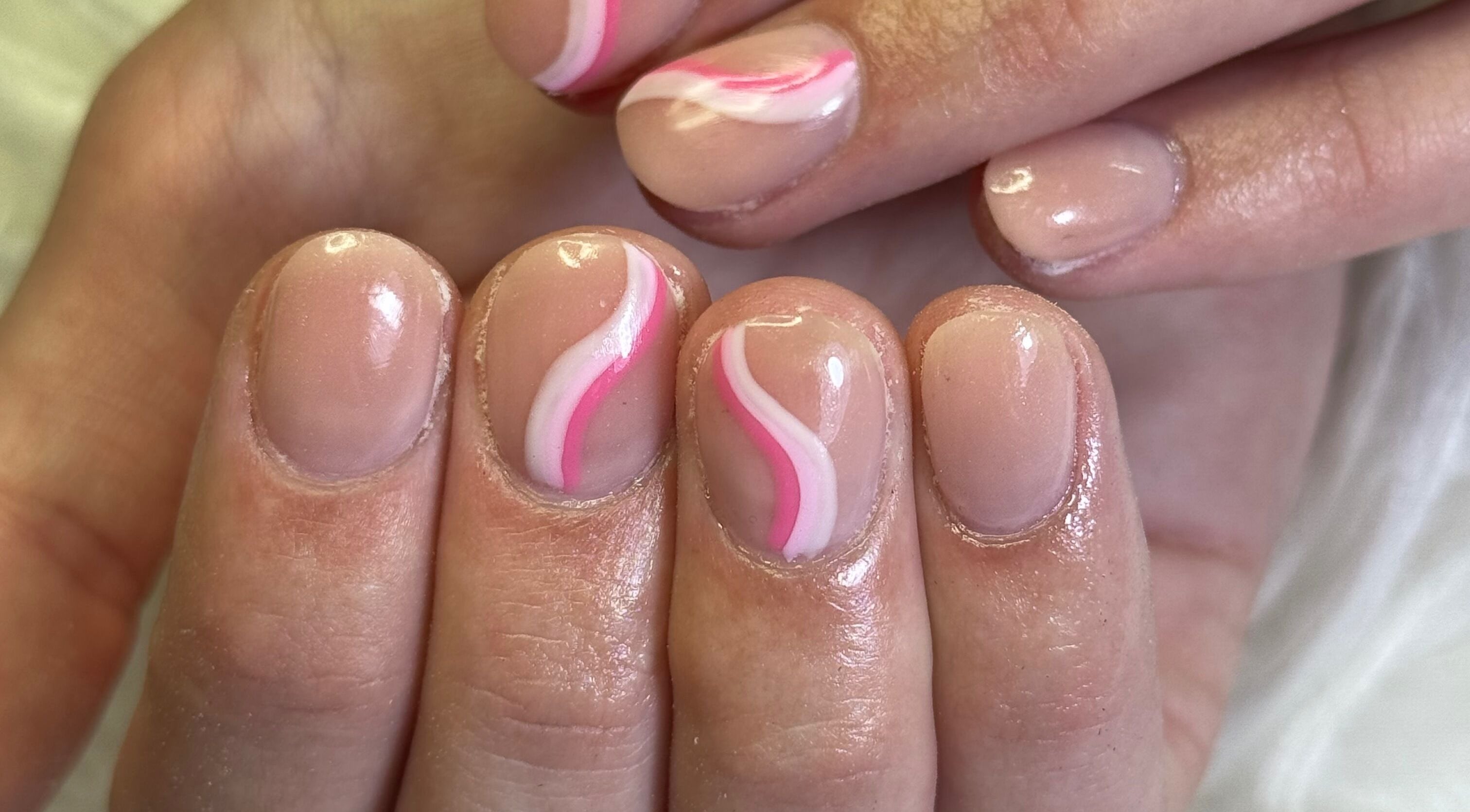 Elegant nail art with pink swirls at Amity Beauty Salon, Potchefstroom, North West, ZA.