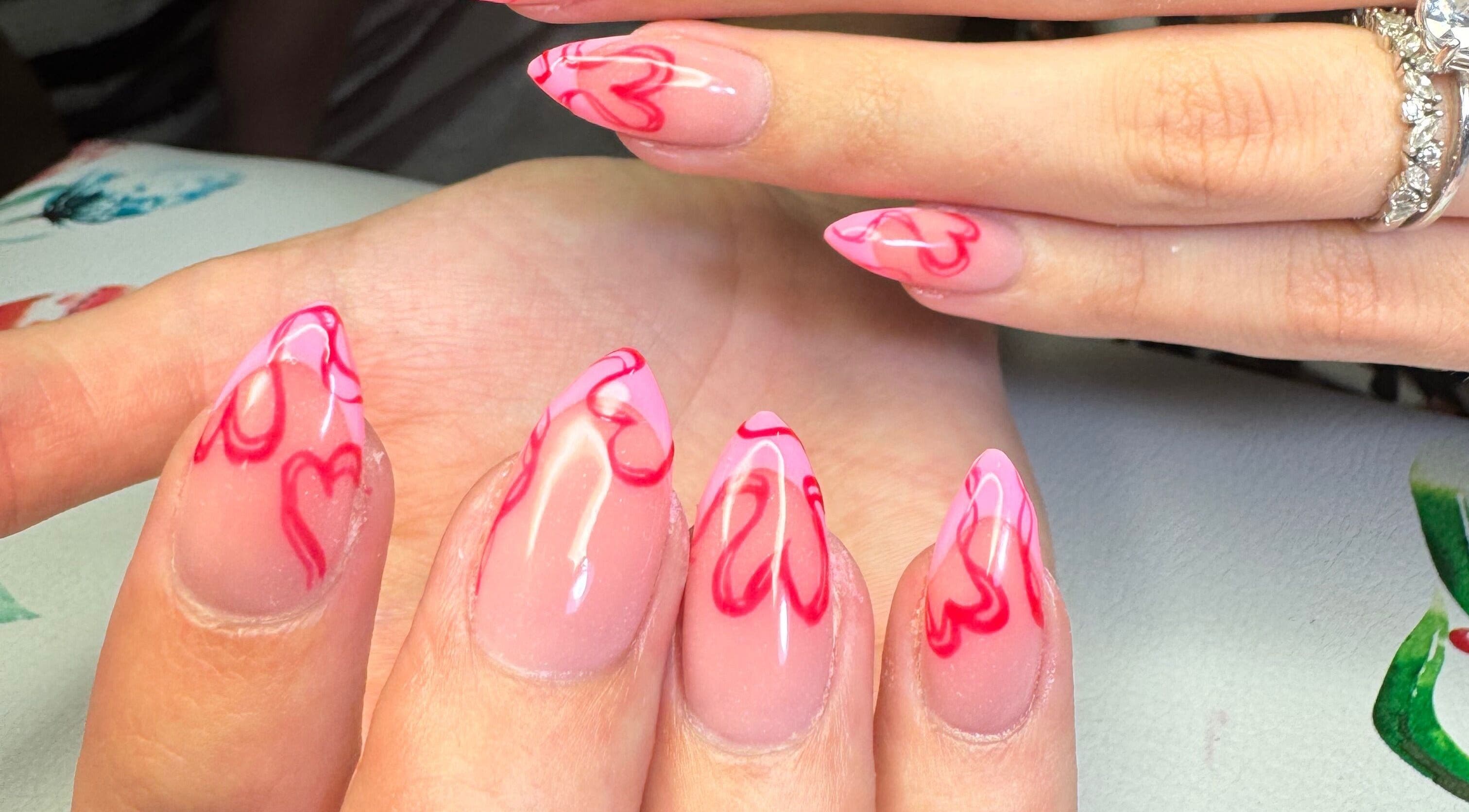 Stylish heart-tipped nail art on hands at Amity Beauty Salon, Potchefstroom, North West, ZA.