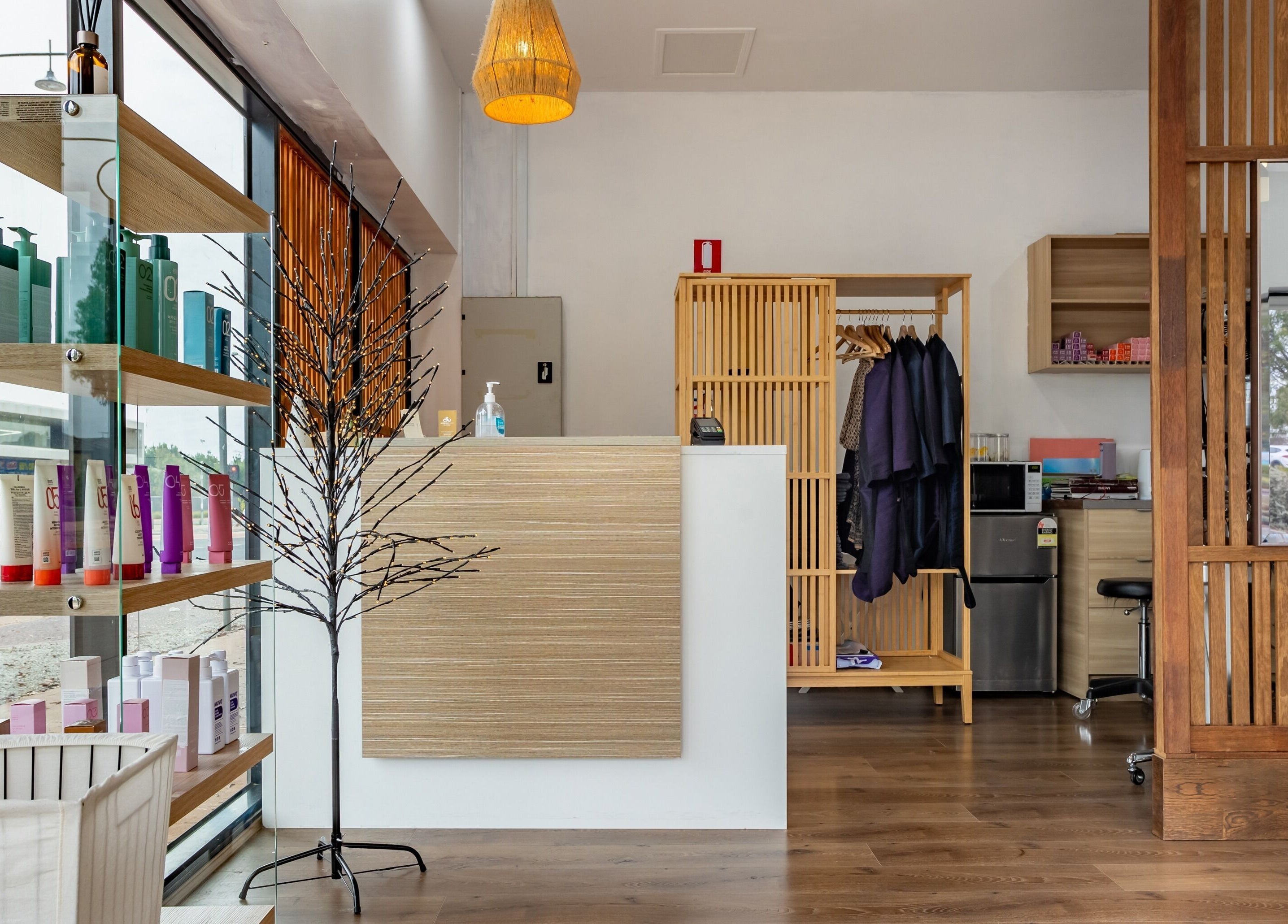 Modern reception at Ribbon Hair - Point Cook, Melbourne, Victoria, AU with stylish decor and product shelves.