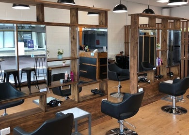 Interior of Ribbon Hair - Darwin salon with modern chairs and mirrors, Darwin City, Northern Territory, AU.