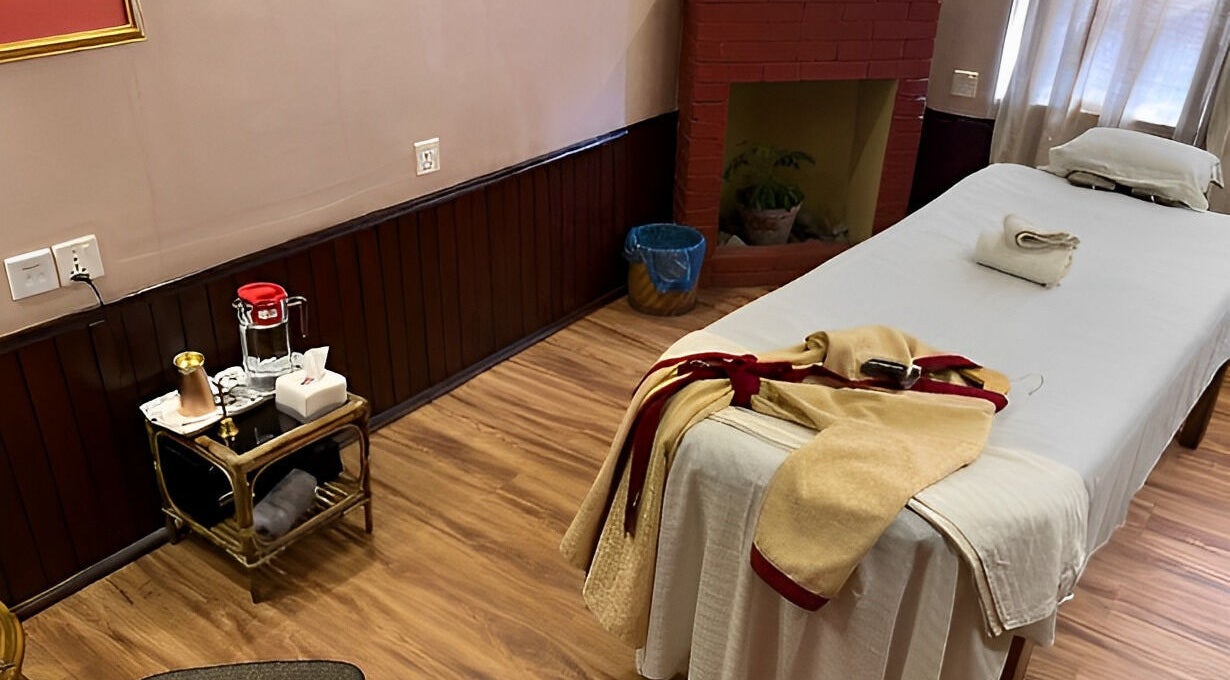 Relaxing spa room at Chaitanya Health & Wellness Pvt. Ltd., Lalitpur, Bagmati Province, NP with a massage table and towels.