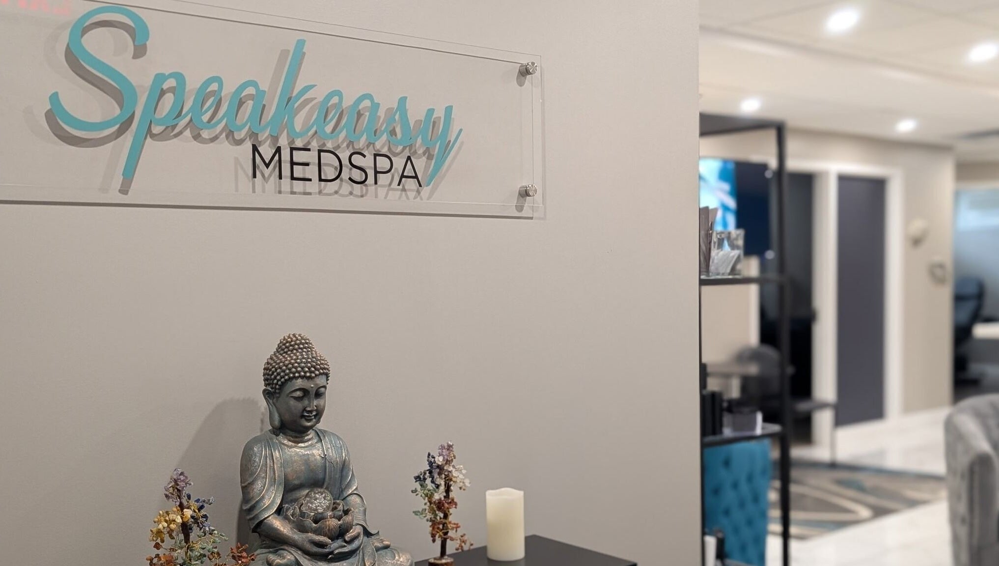 Interior of Speakeasy Med Spa featuring a serene Buddha statue in Hamilton, Ontario, CA.