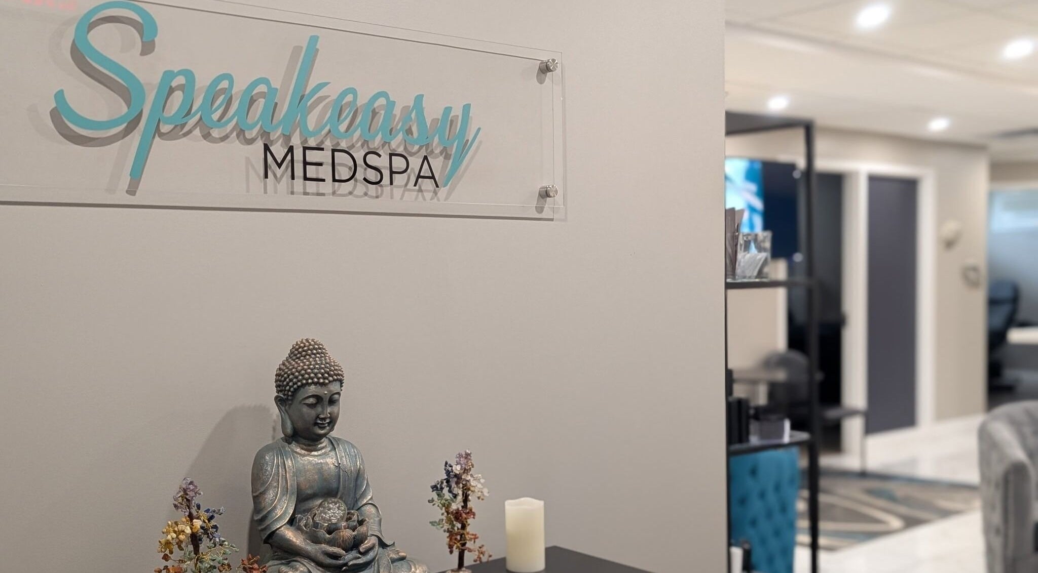 Interior of Speakeasy Med Spa featuring a serene Buddha statue in Hamilton, Ontario, CA.