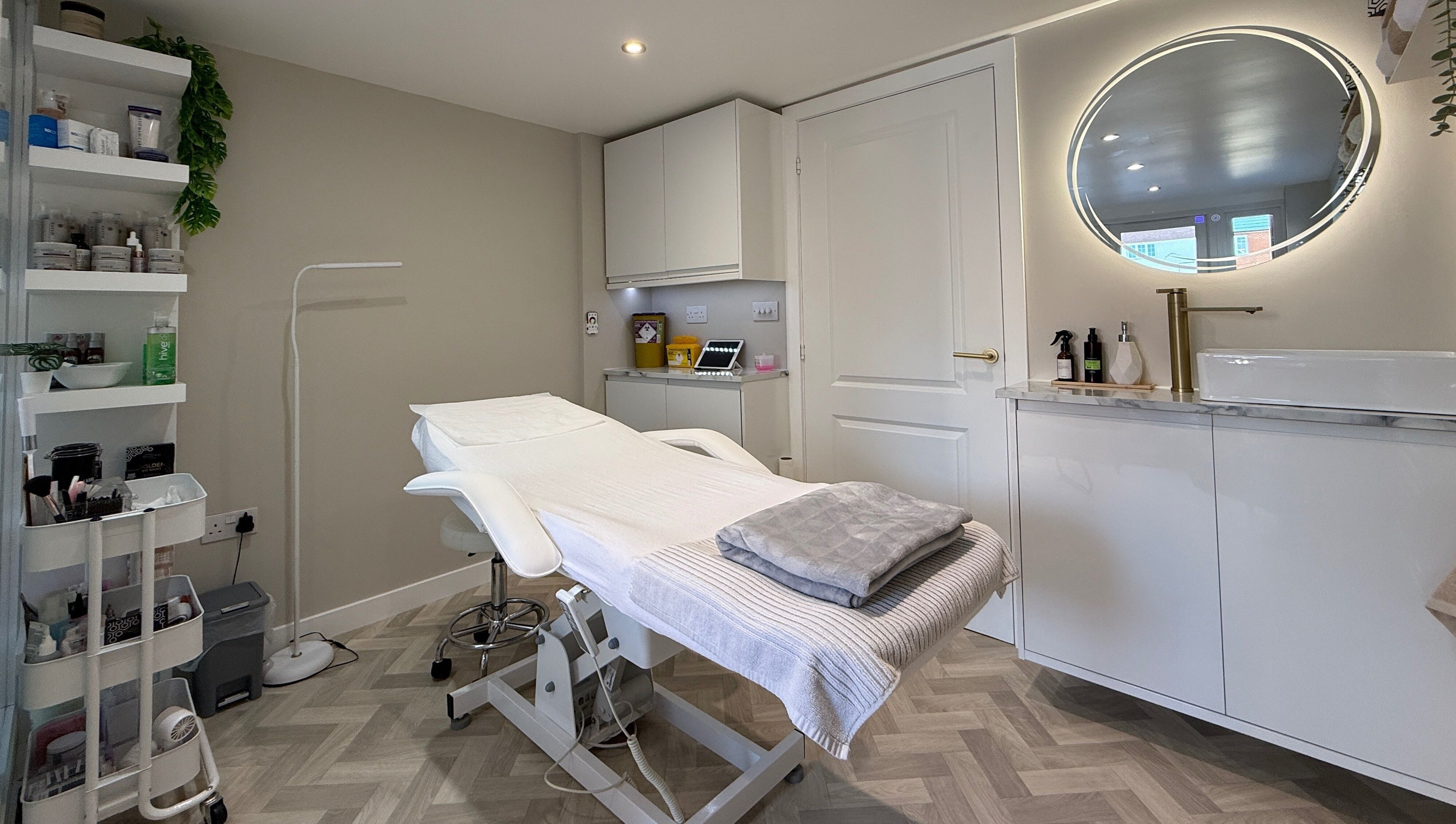 Chic treatment room at Plush Beauty Box, Exeter, England, GB with modern decor and comfortable bed.